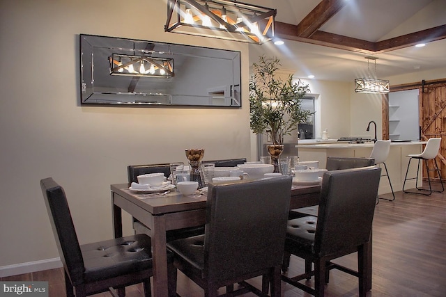 dining room with a barn door and hardwood / wood-style flooring