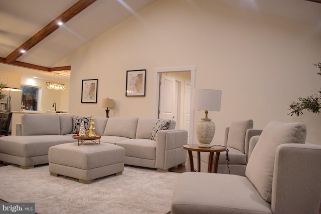 living room featuring beam ceiling and high vaulted ceiling