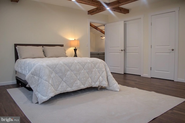 bedroom with ceiling fan, beamed ceiling, and dark hardwood / wood-style floors