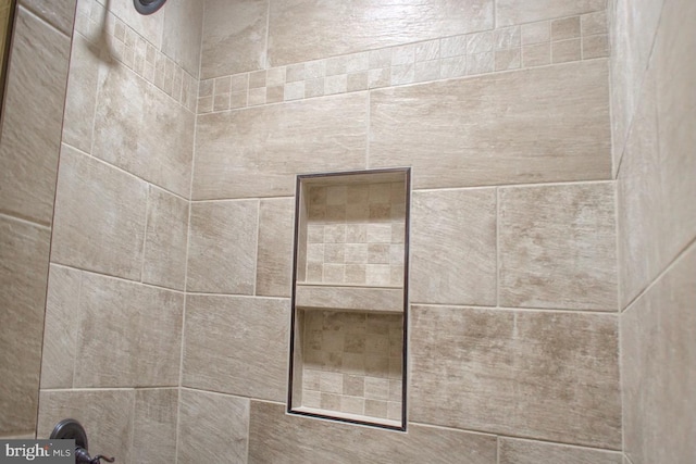 interior details featuring a tile shower