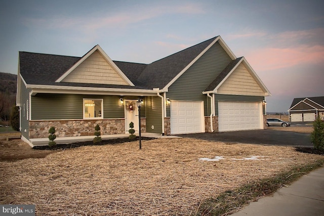 126 Saffron Blvd, Centre Hall, PA 16828 - craftsman house featuring stone siding, driveway, covered porch, and an attached garage