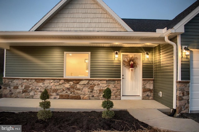 view of exterior entry featuring covered porch