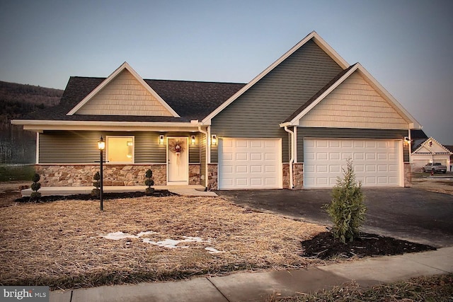 126 Saffron Blvd, Centre Hall, PA 16828 - view of front of house with driveway, a garage, and stone siding