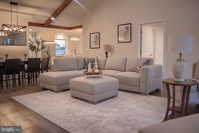 living room featuring beamed ceiling, wood-type flooring, and high vaulted ceiling