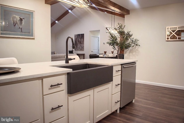 kitchen featuring dark hardwood / wood-style flooring, stainless steel dishwasher, sink, pendant lighting, and white cabinetry