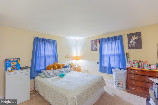 bedroom featuring light carpet