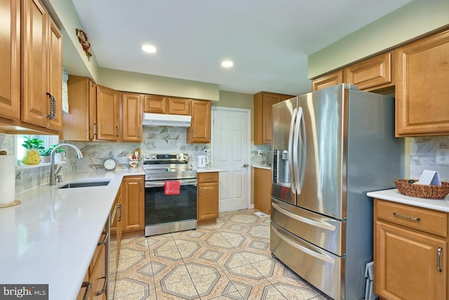 kitchen with appliances with stainless steel finishes, tasteful backsplash, light tile patterned floors, and sink