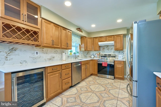 kitchen with backsplash, sink, light tile patterned flooring, stainless steel appliances, and beverage cooler