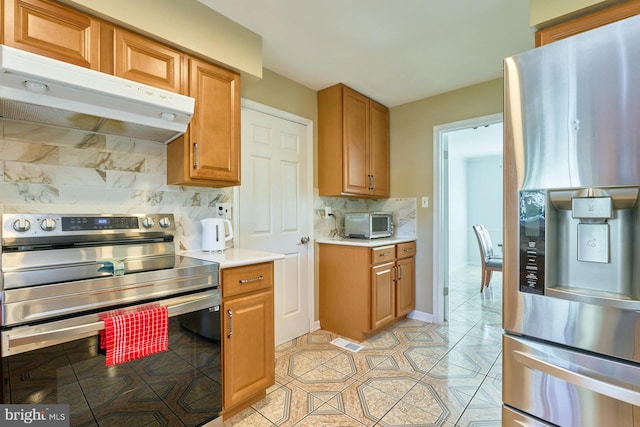 kitchen featuring backsplash and appliances with stainless steel finishes