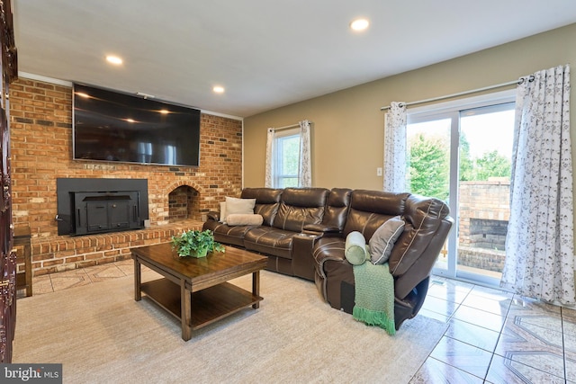 living room with plenty of natural light, light tile patterned flooring, and brick wall