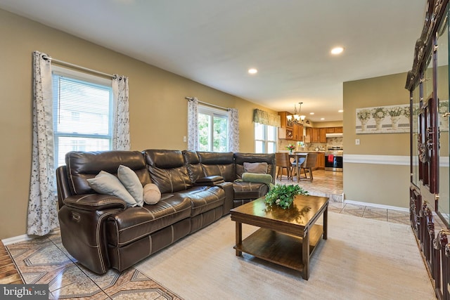 living room featuring light tile patterned floors and a chandelier