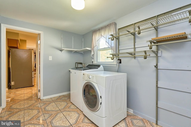 laundry room with light tile patterned floors and washer and dryer