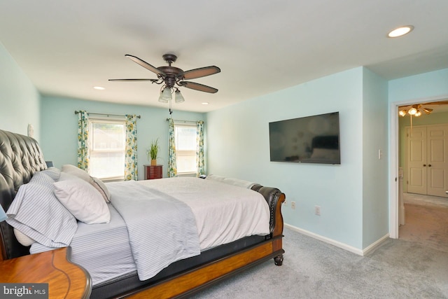 bedroom featuring ceiling fan and light carpet