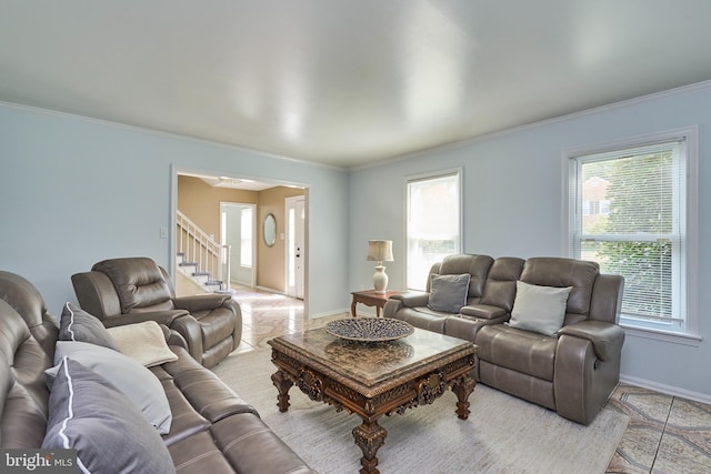 living room with light tile patterned floors and ornamental molding