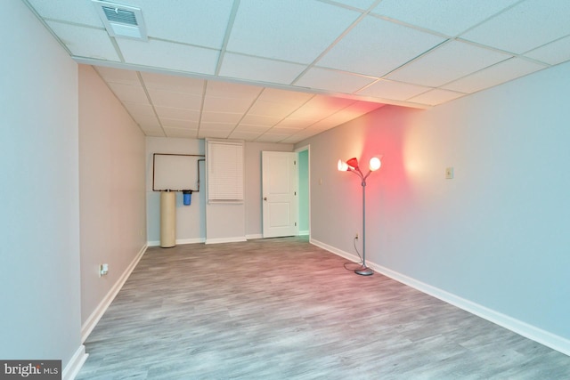 basement with hardwood / wood-style floors and a drop ceiling