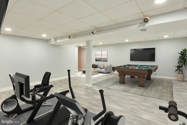 interior space with light wood-type flooring, a drop ceiling, and pool table