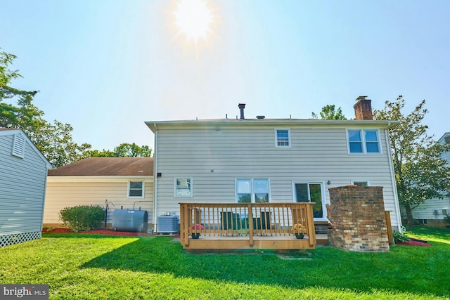 back of property with a lawn, central AC, and a wooden deck