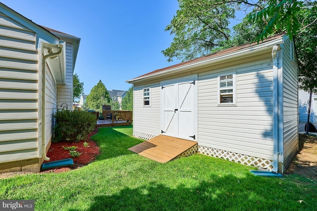 view of outbuilding with a yard