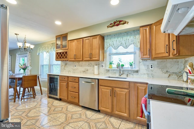 kitchen with sink, beverage cooler, an inviting chandelier, stainless steel dishwasher, and extractor fan