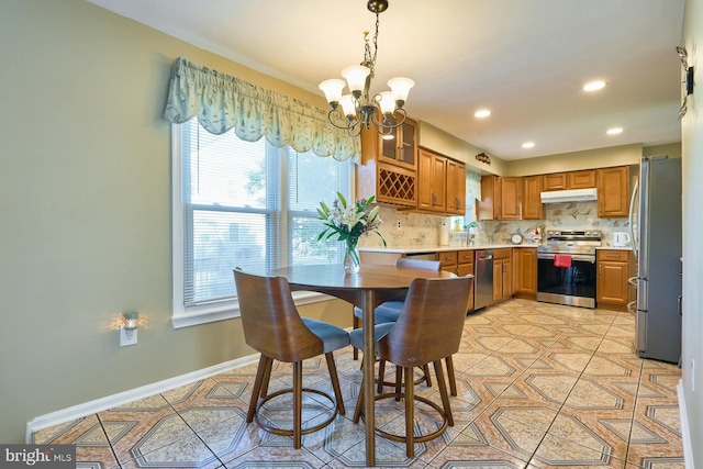 dining room with sink, light tile patterned floors, and a chandelier