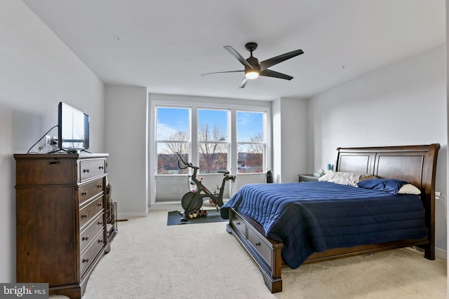 bedroom with ceiling fan and light carpet