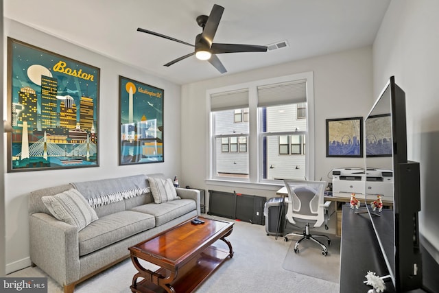 carpeted home office featuring ceiling fan