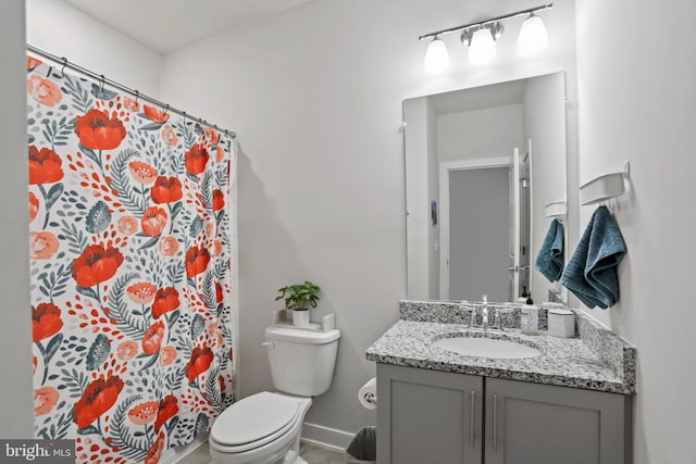 bathroom featuring vanity, toilet, and walk in shower