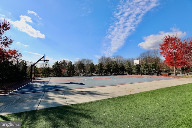 view of sport court featuring a lawn