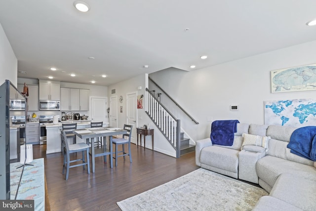 living room with dark hardwood / wood-style flooring