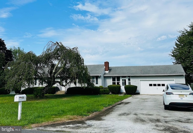 single story home with a front yard and a garage