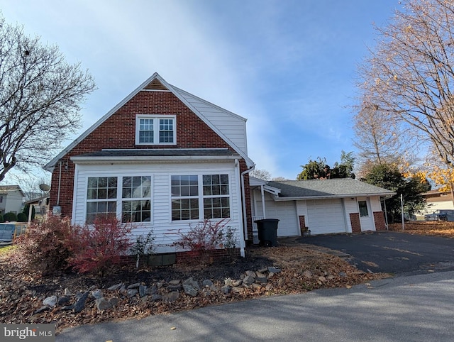 view of side of home with brick siding and a garage