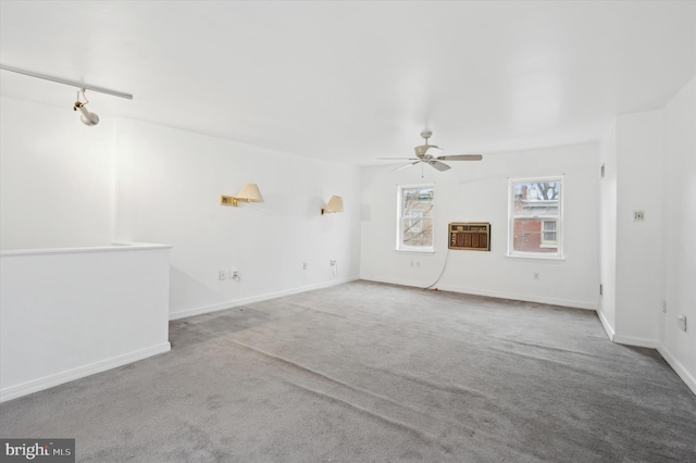 unfurnished living room with light colored carpet, ceiling fan, and a wall mounted air conditioner