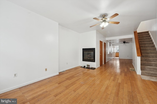 unfurnished living room with ceiling fan and light hardwood / wood-style floors