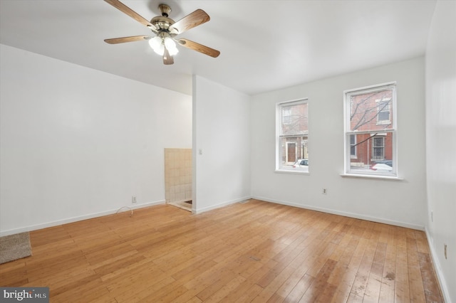 unfurnished room featuring ceiling fan and light hardwood / wood-style flooring