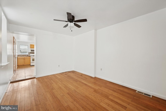 unfurnished living room with ceiling fan and light hardwood / wood-style floors