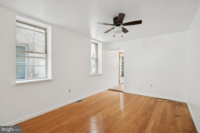 spare room featuring ceiling fan and light hardwood / wood-style flooring