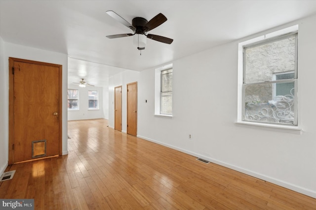 unfurnished room with ceiling fan and wood-type flooring