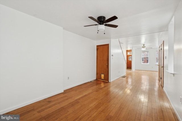 empty room featuring ceiling fan and light hardwood / wood-style floors