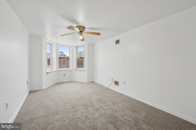 carpeted empty room with ceiling fan