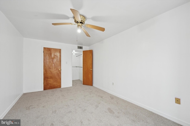 unfurnished bedroom with ceiling fan and light carpet