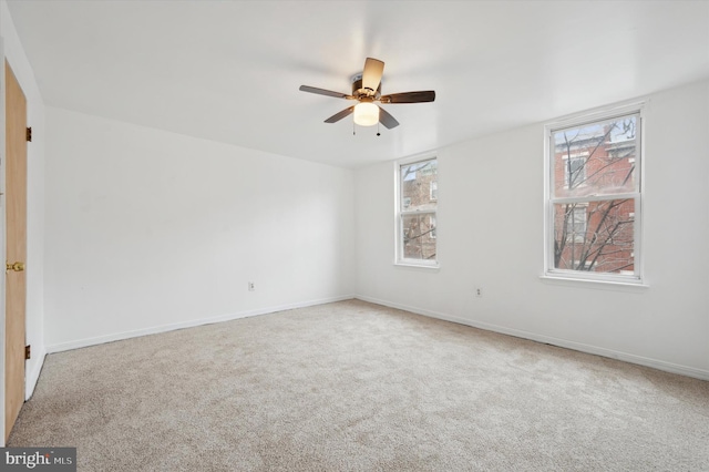 spare room featuring ceiling fan and carpet flooring