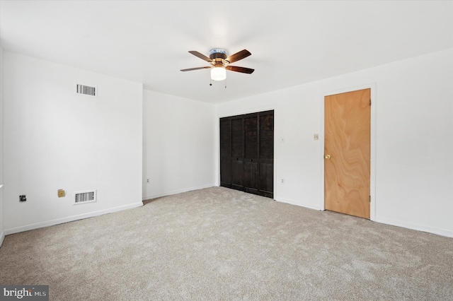 unfurnished bedroom featuring light colored carpet and ceiling fan