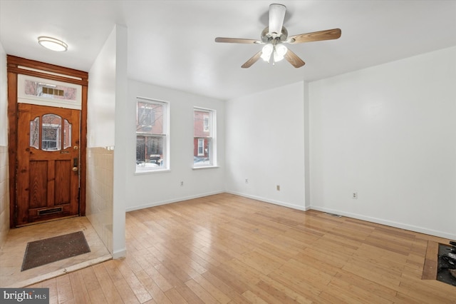 foyer featuring ceiling fan and light wood-type flooring