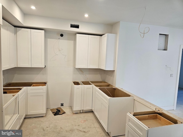 kitchen featuring white cabinets and recessed lighting