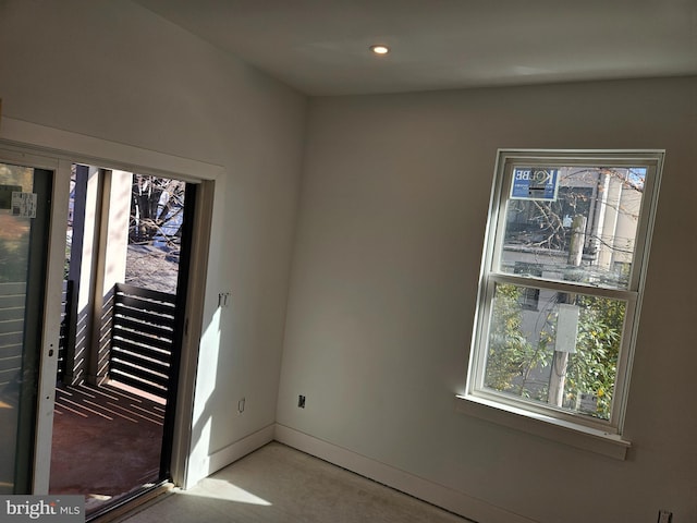 unfurnished room with recessed lighting and baseboards