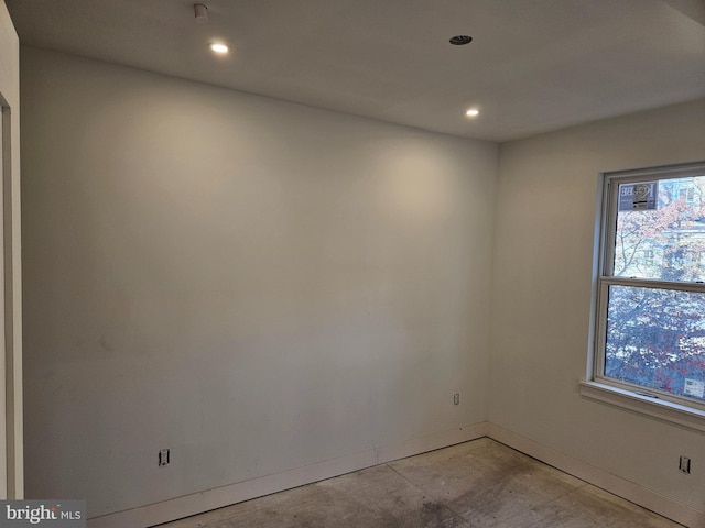 empty room with recessed lighting and baseboards