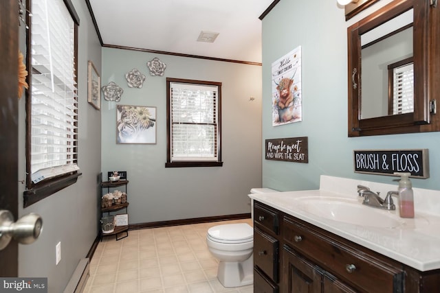 bathroom featuring a baseboard radiator, a wealth of natural light, toilet, and vanity