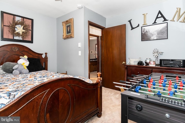 bedroom featuring light carpet