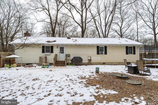 snow covered house with a trampoline