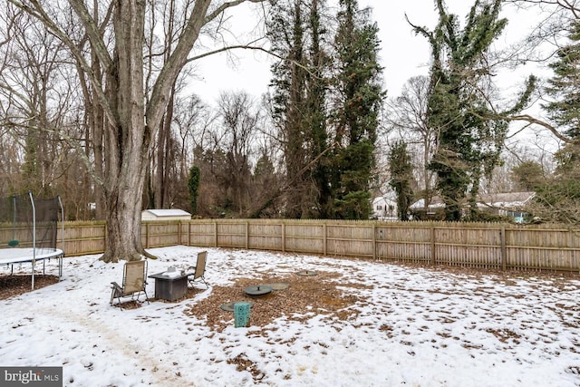 snowy yard with a trampoline